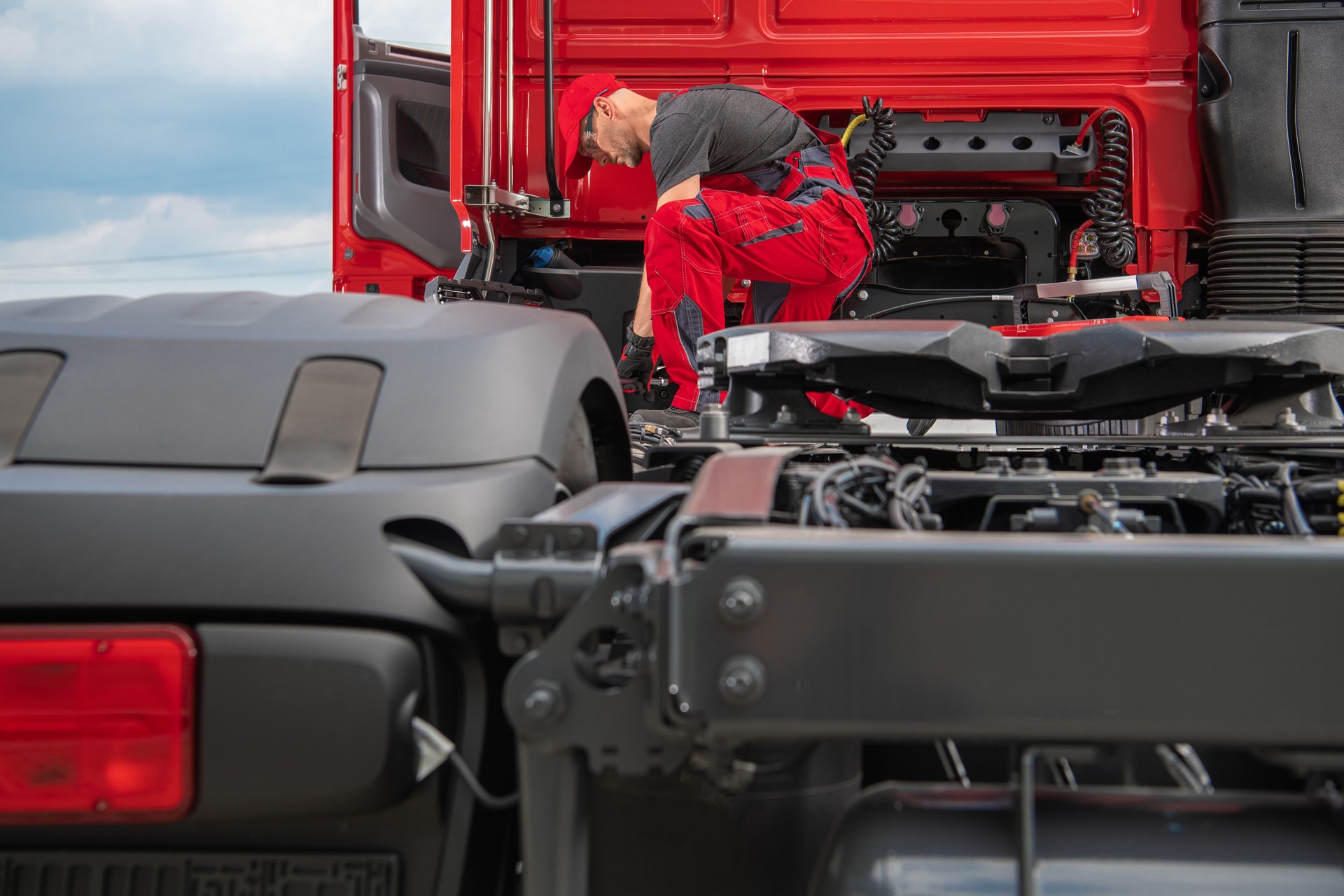 Semi truck service center maintenance performed by a professional caucasian technician