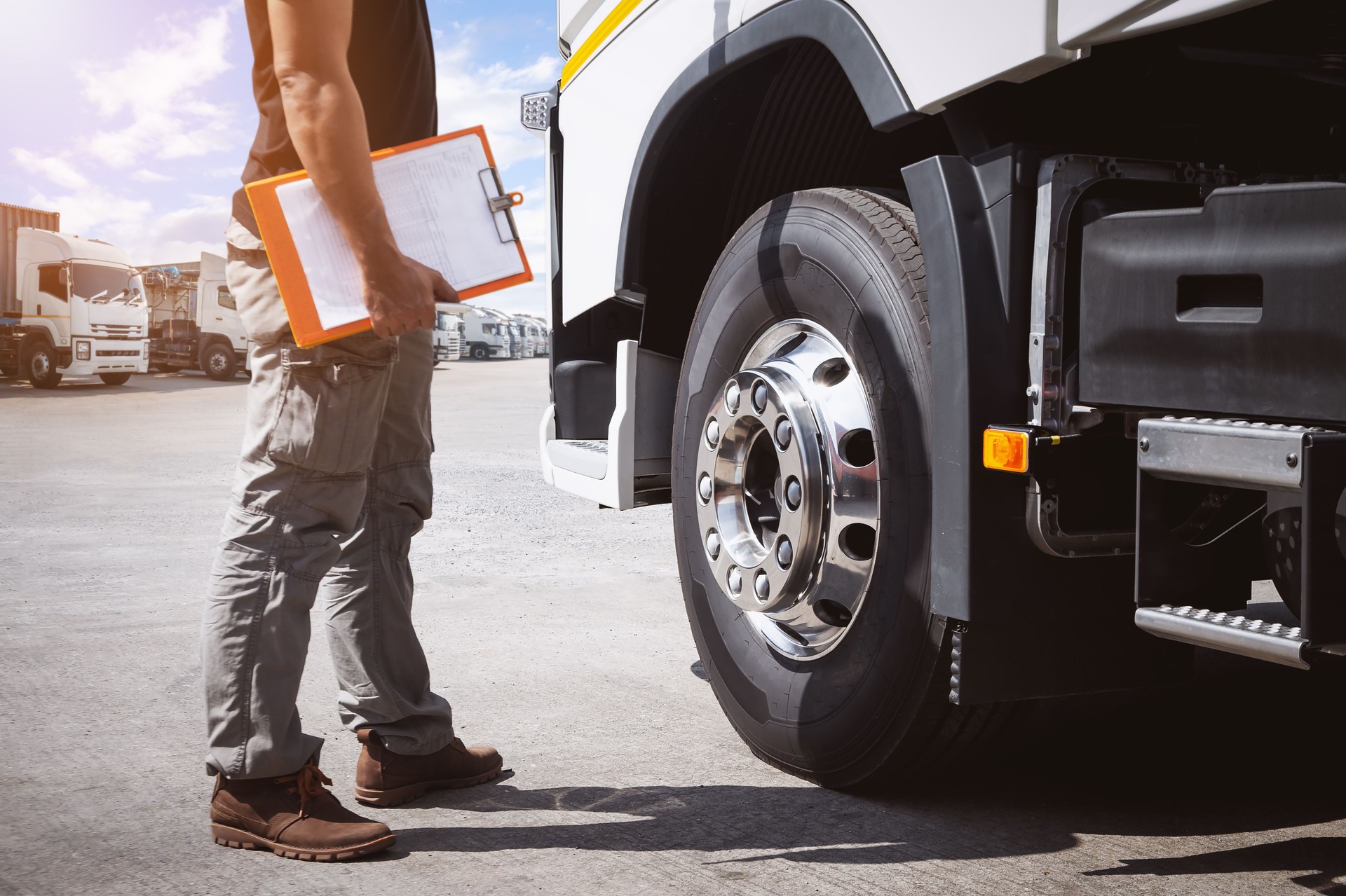 Fleet repair service Holding Clipboard to Check Truck Tires. Semi Truck Tractor, Big rig. Maintenance Safety Checklist, Inspecting Safety Driving. Freight Logistics  Truck Transportation.